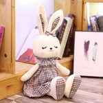 lapin blanc peluche brun assis